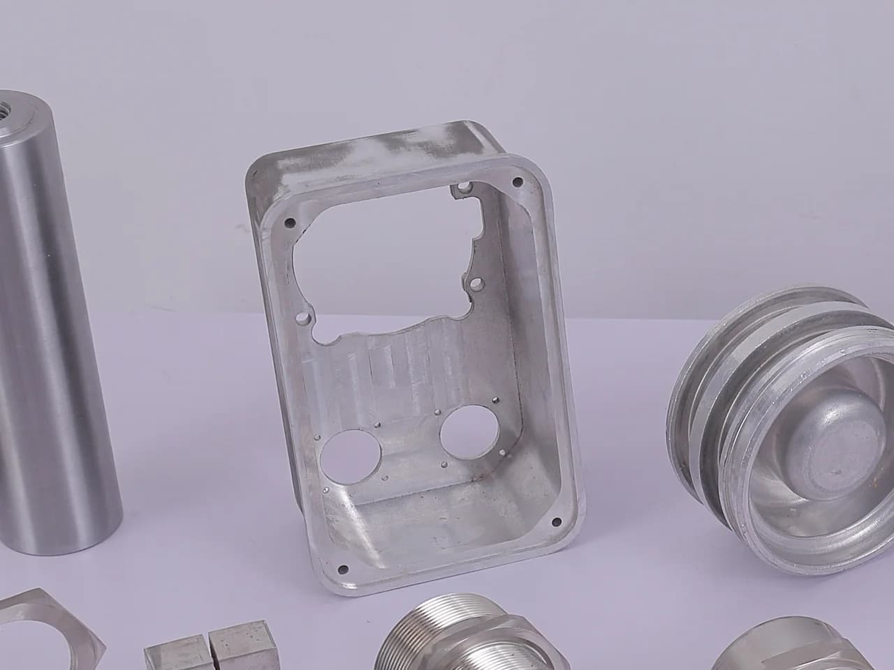 Machined stainless plate with cut-outs, a split clamp block and a turned ring