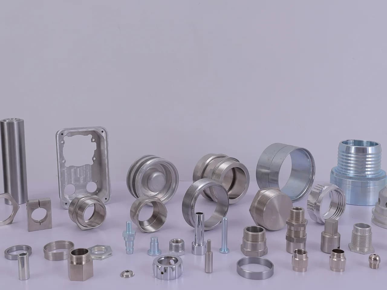 Stainless and aluminium turned and milled components — shafts, rings, bushes, a machined plate and small pins